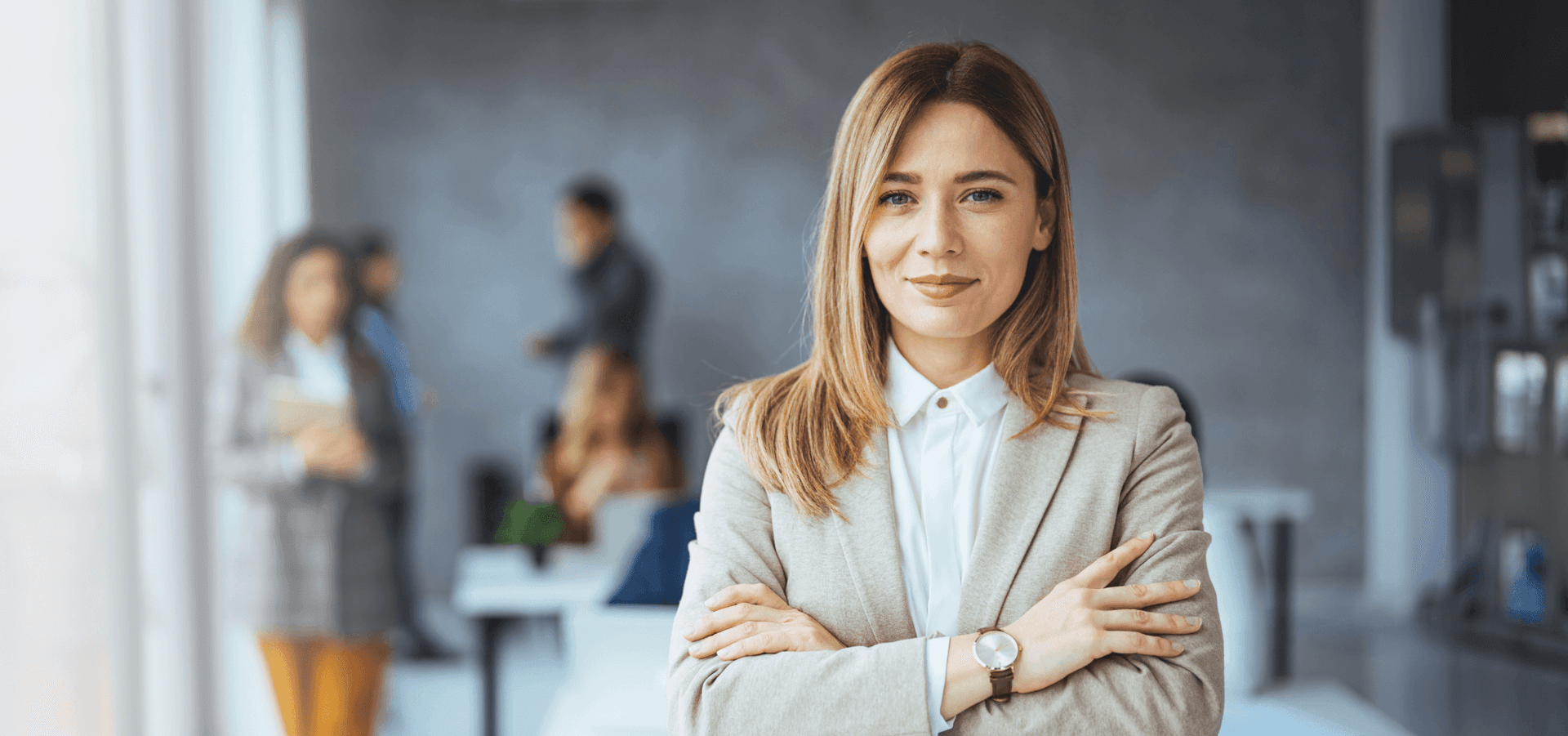 Portrait of beautiful businesswoman standing in front of business team.