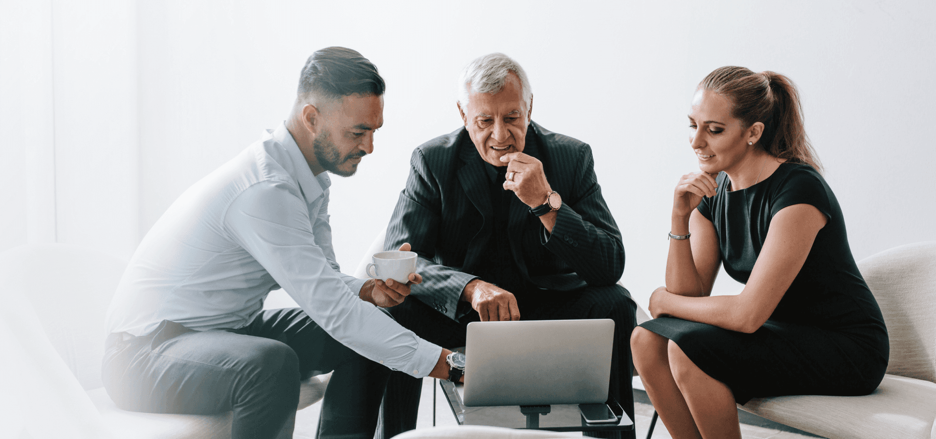 Group of three business professionals working together on new business plan.